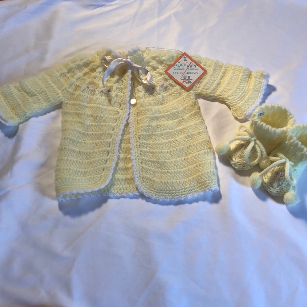 Vintage hand knitted baby sweater and booties.